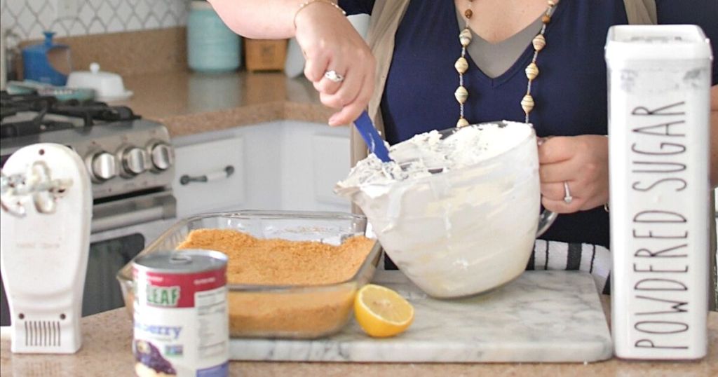 woman stirring frosting in anchor hocking bowl