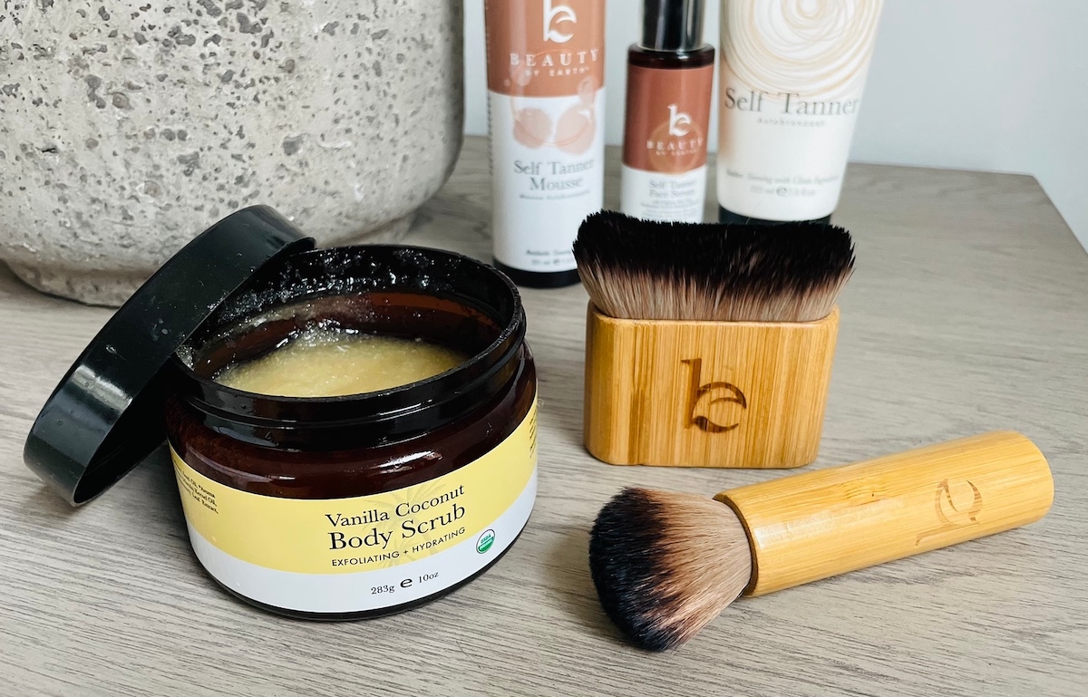 beauty by earth vanilla coconut body scrub and brushes on wood table