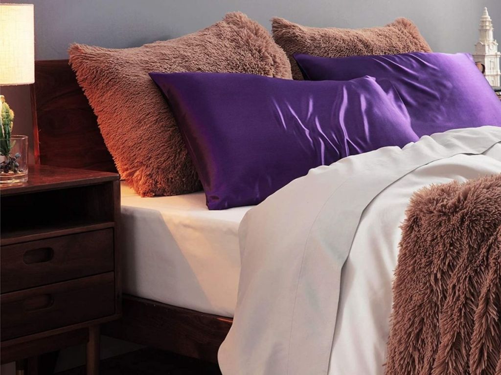 purple satin pillowcase on bed