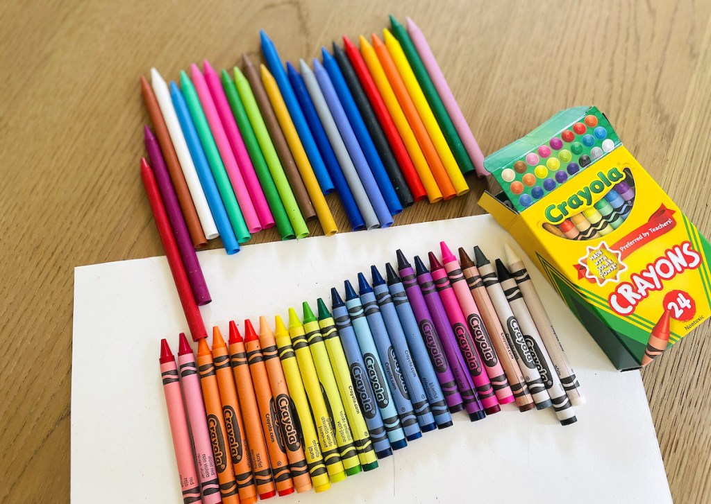 row of rainbow best crayons on table with crayola box
