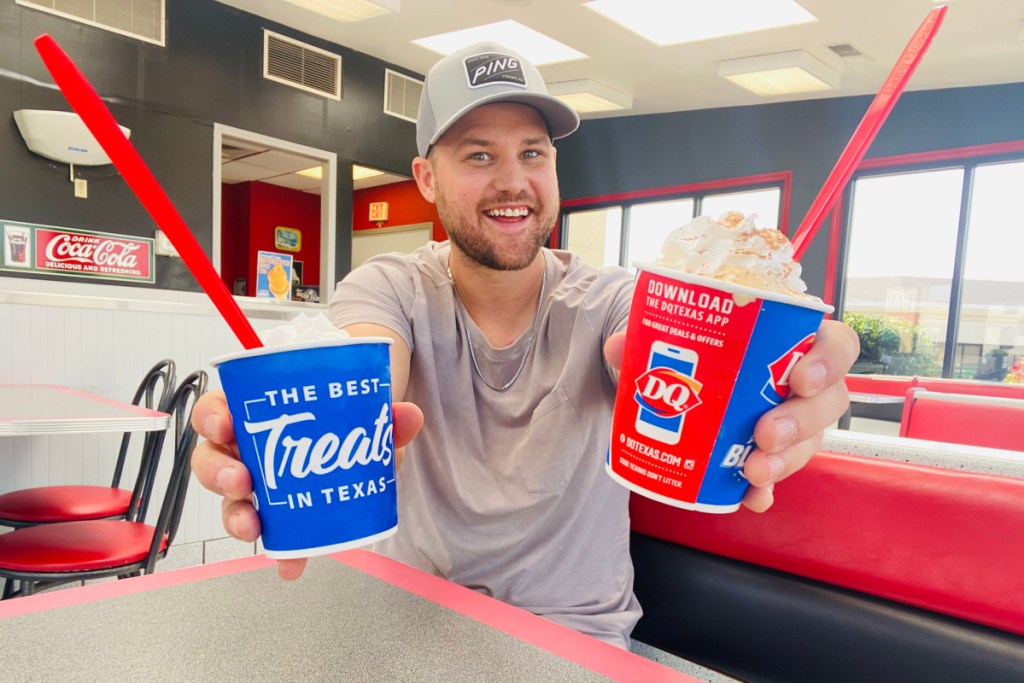 man holding blizzards of the month at dairy queen