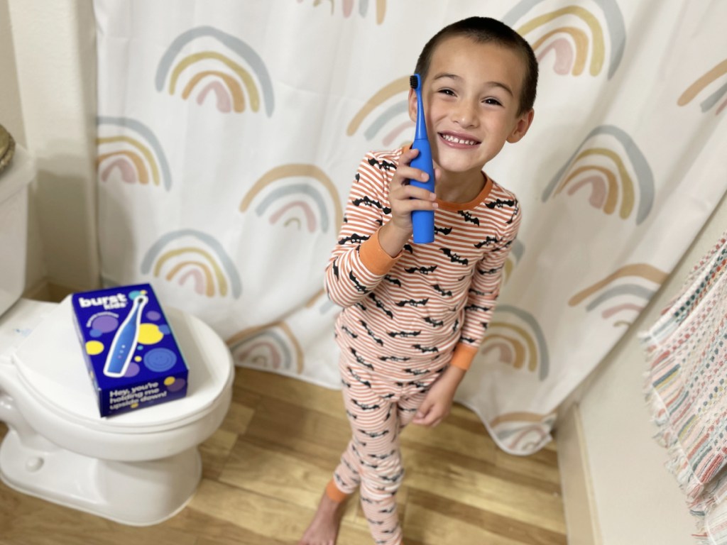 boy holding burst toothbrusj