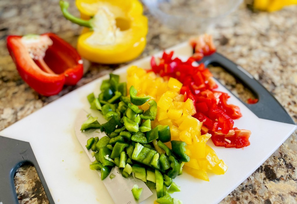 green yellow and red chopped bell peppers on cutting board