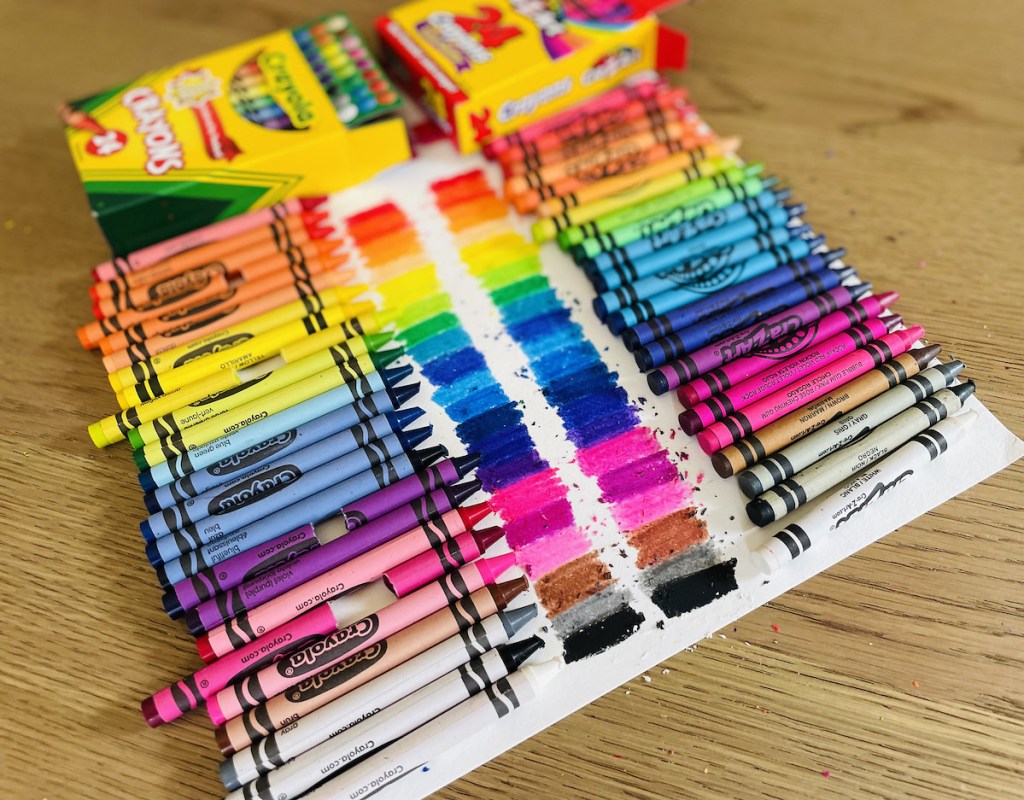 crayons in rainbow with coloring on paper