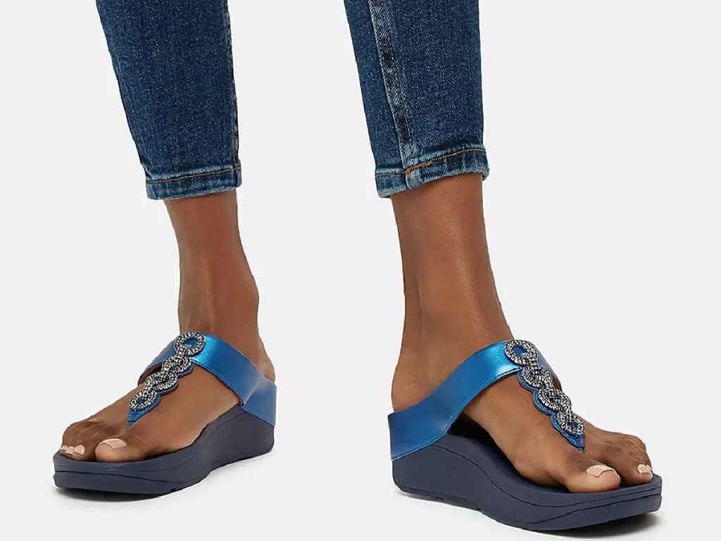 woman's feet with blue sandals