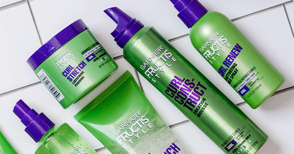 garnier fructis styling products for curly hair laid out on tile