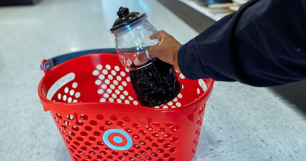hand holding gumball machine in target basket