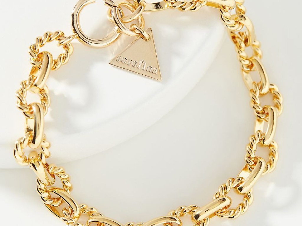 gold chain bracelet on white background