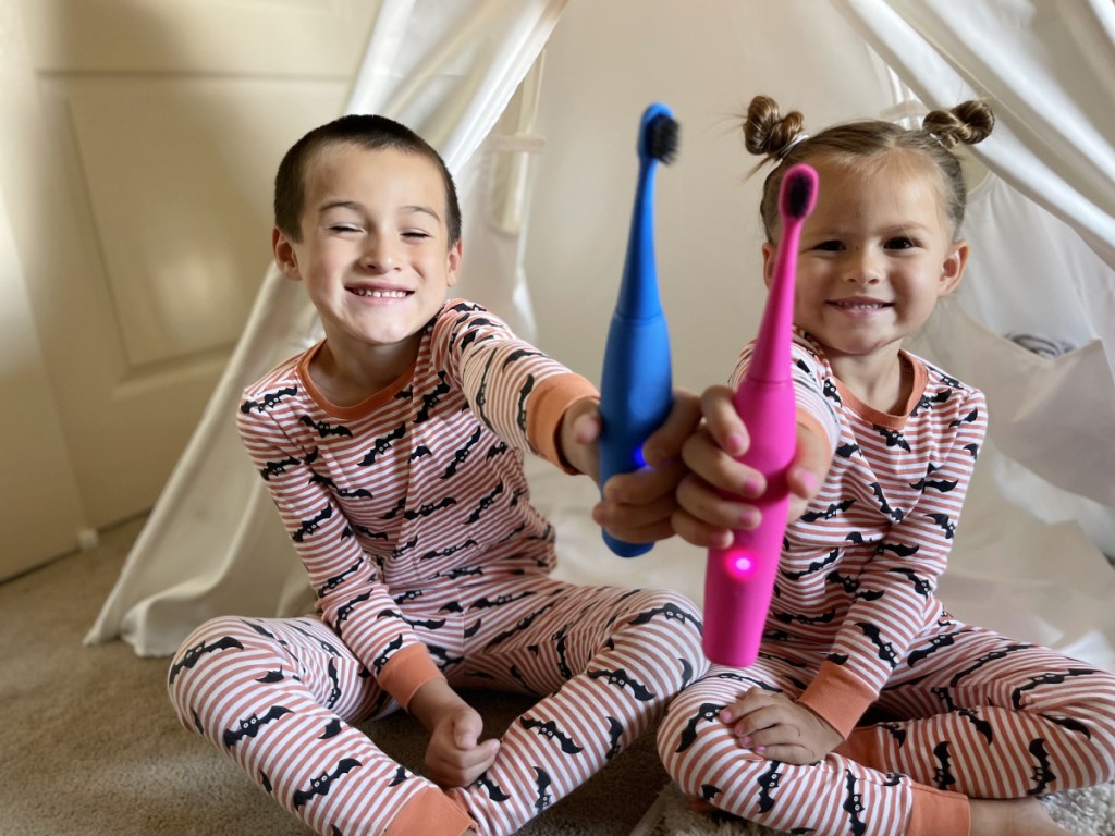 kids holding burst toothbrushes