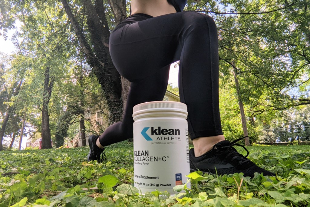 woman kneeling next to Klean Athlete Collagen + Vitamin C powder