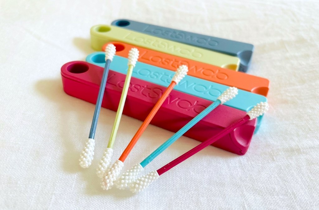 colorful reusable q tips on last swab cases on white sheet