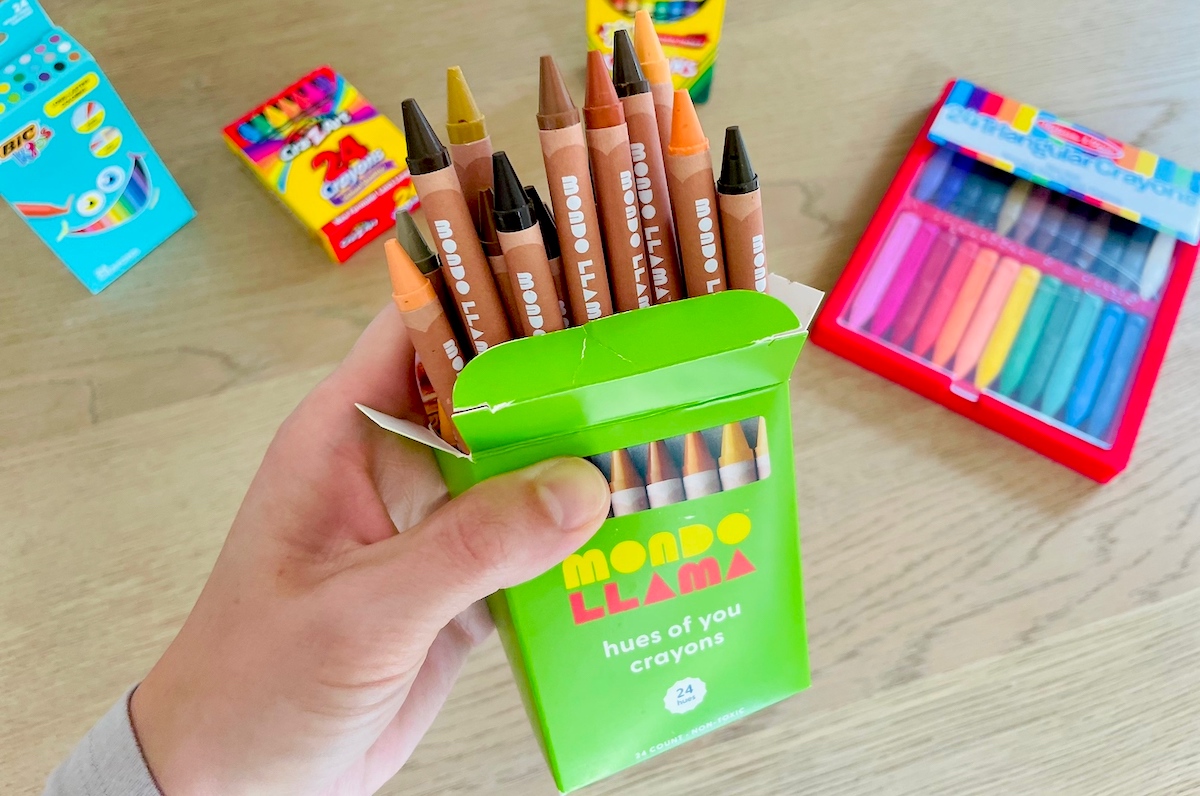 hand holding a box of mondo llama crayons