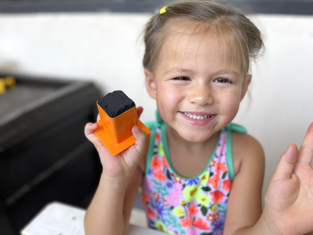 little girl playing with Kinetic sand 