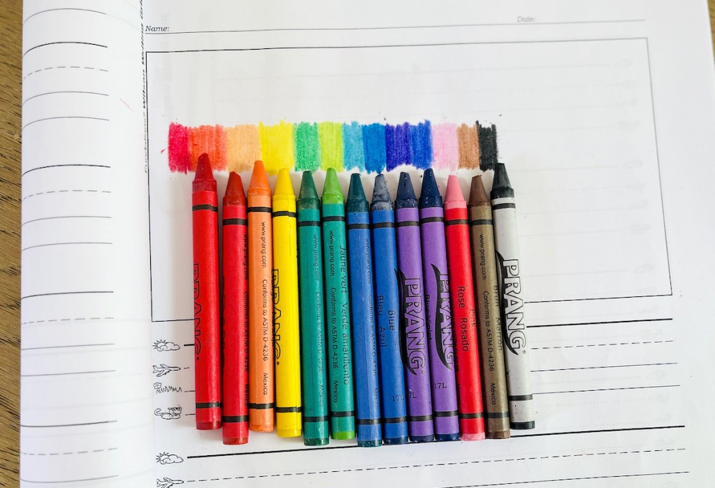 row of prang crayons on white paper