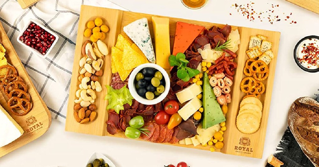 charcuterie board with cheese, meats, vegetables, nuts, and crackers
