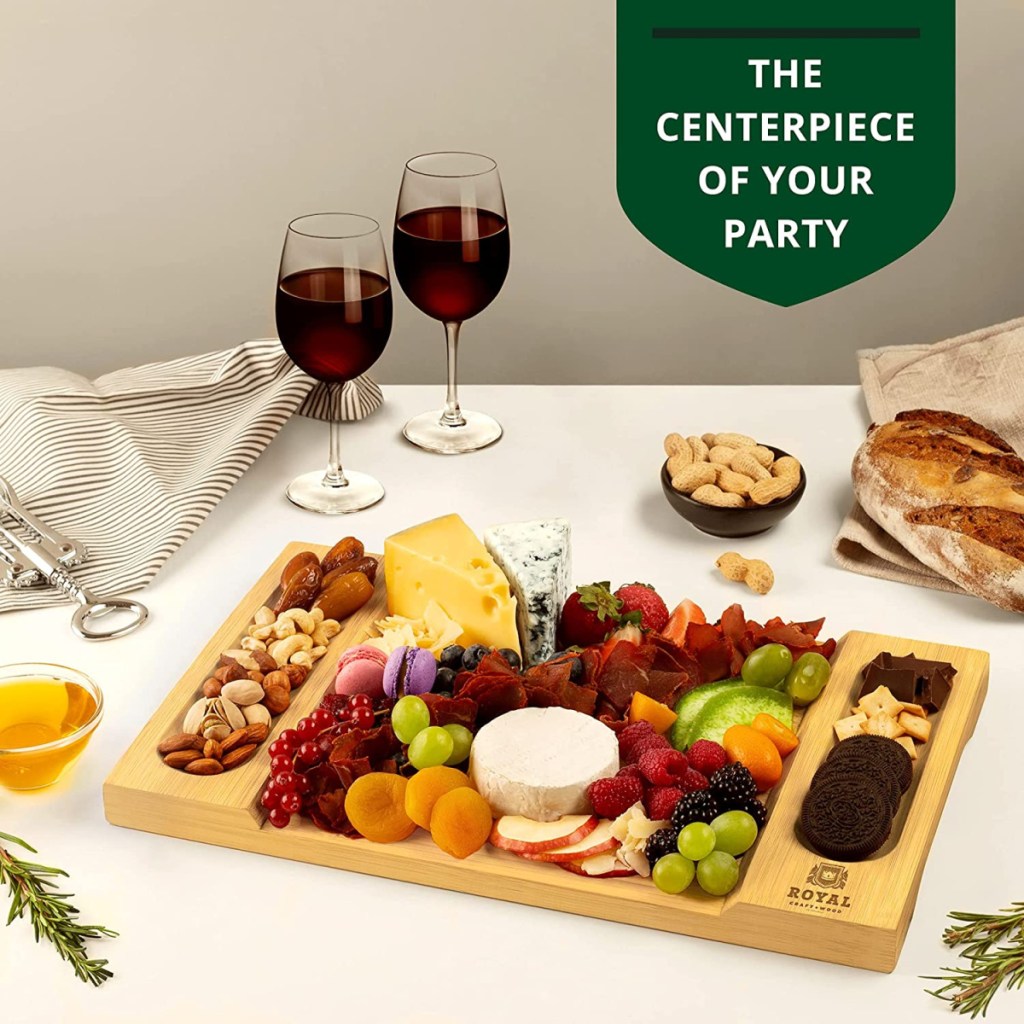full charcuterie board in front of wine glasses on a table
