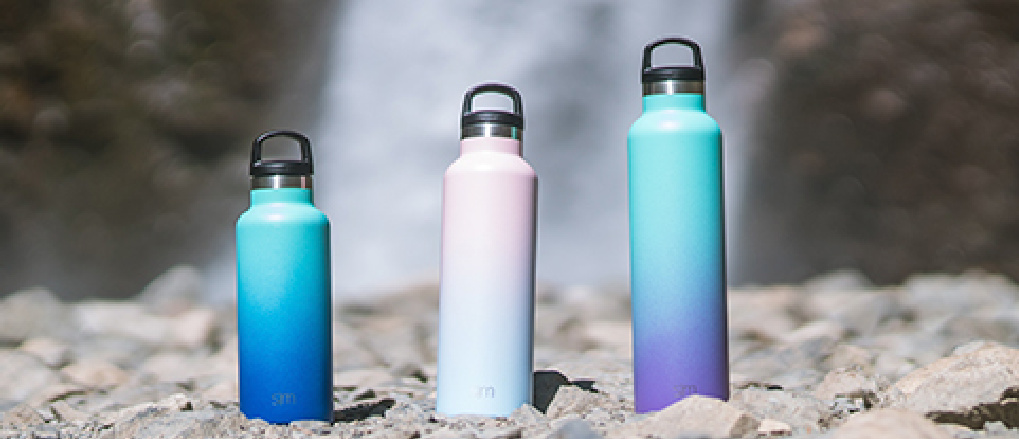 ombre water bottles in the sand