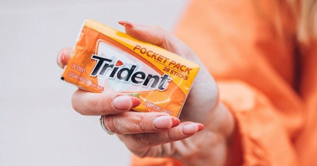 holding a pocket pack of Trident gum