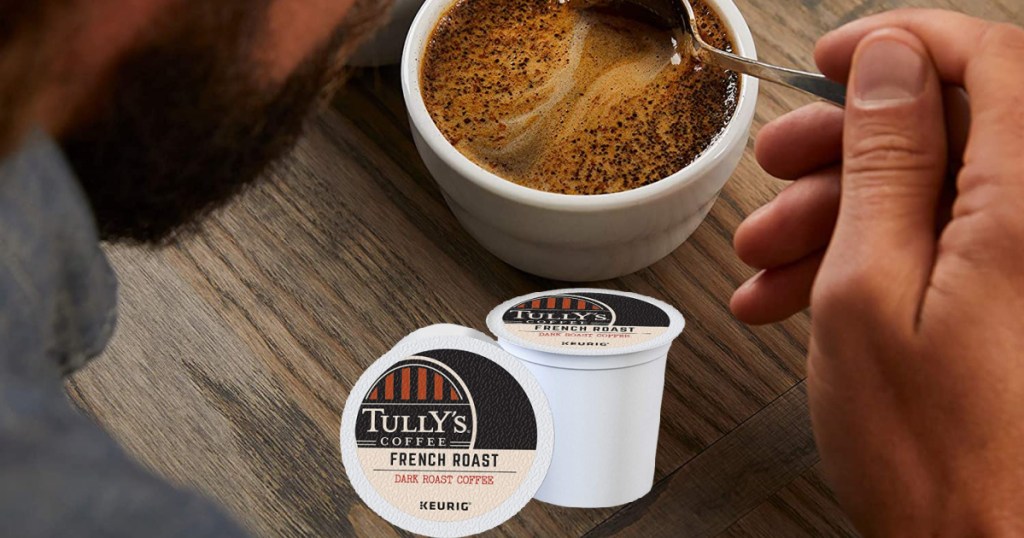 Tully's coffee pods and man swirling spoon in coffee