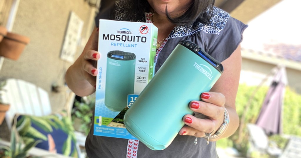 woman holding a thermacell mosquito repellent