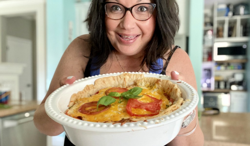 woman holding a tomato pie