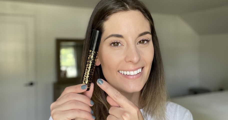 woman holding tarte maneater mascara
