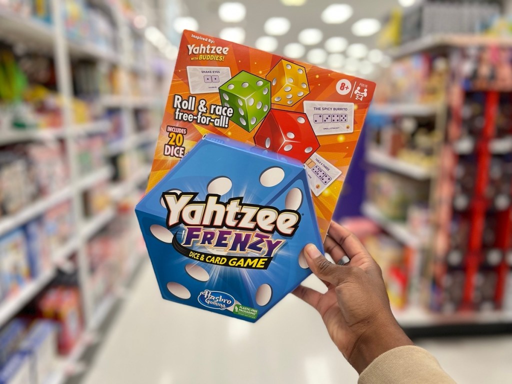 holding a Yahtzee Frenzy card game at Target