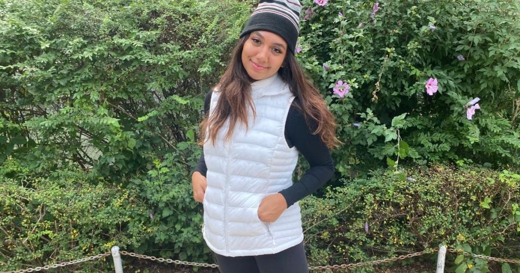woman wearing a white vest and beanie