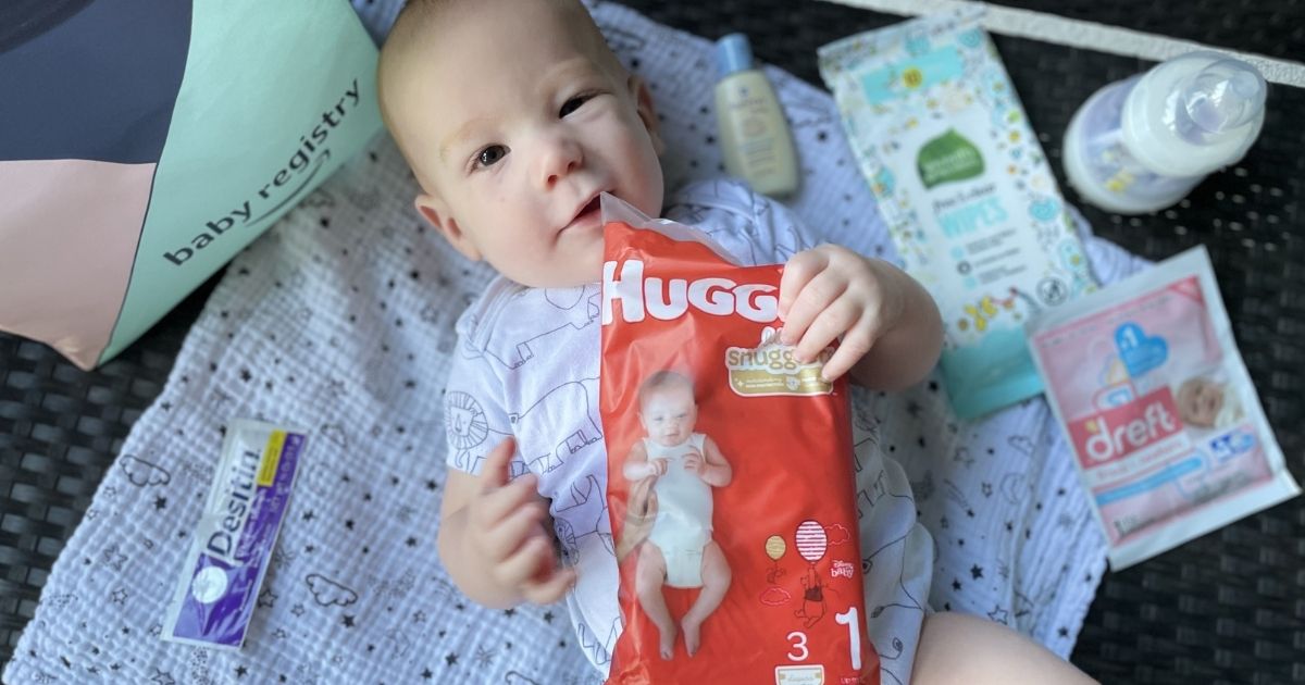 baby holding a sample of diapers
