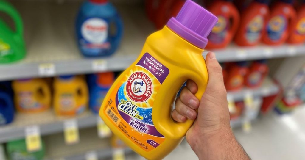 hand holding a bottle of Arm & Hammer laundry detergent
