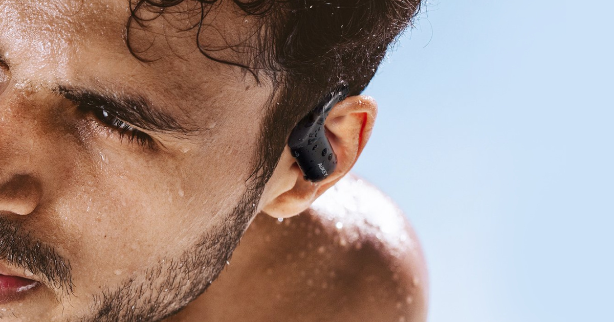 man in water wearing wireless earbuds