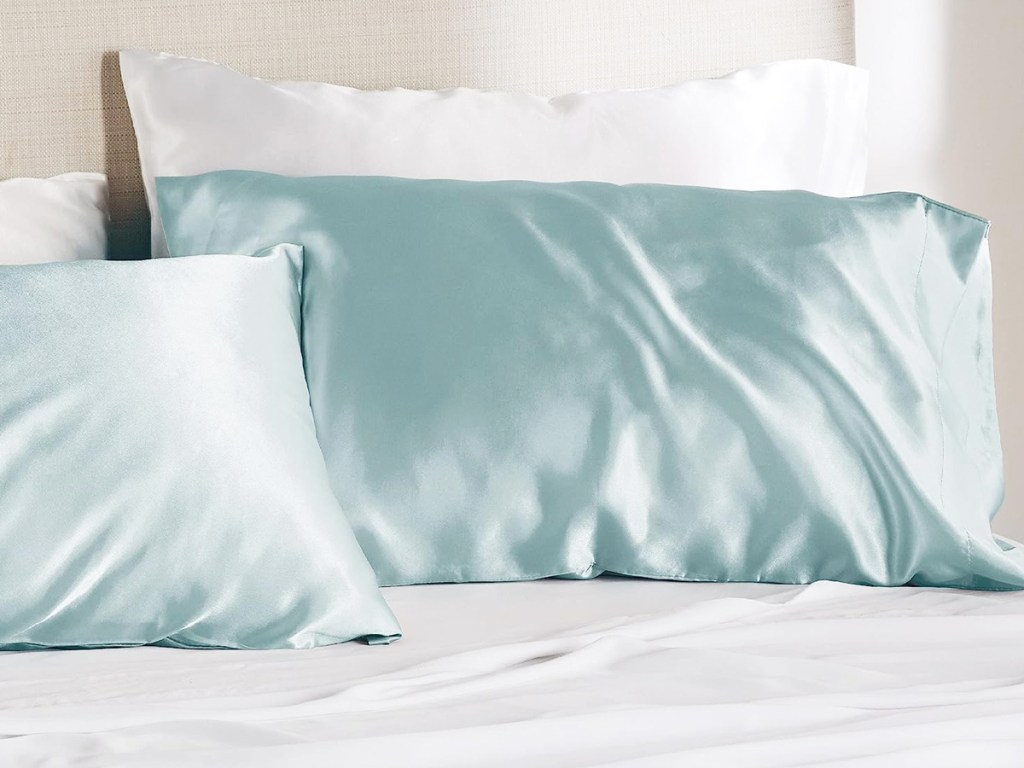 light blue satin pillowcases on bed