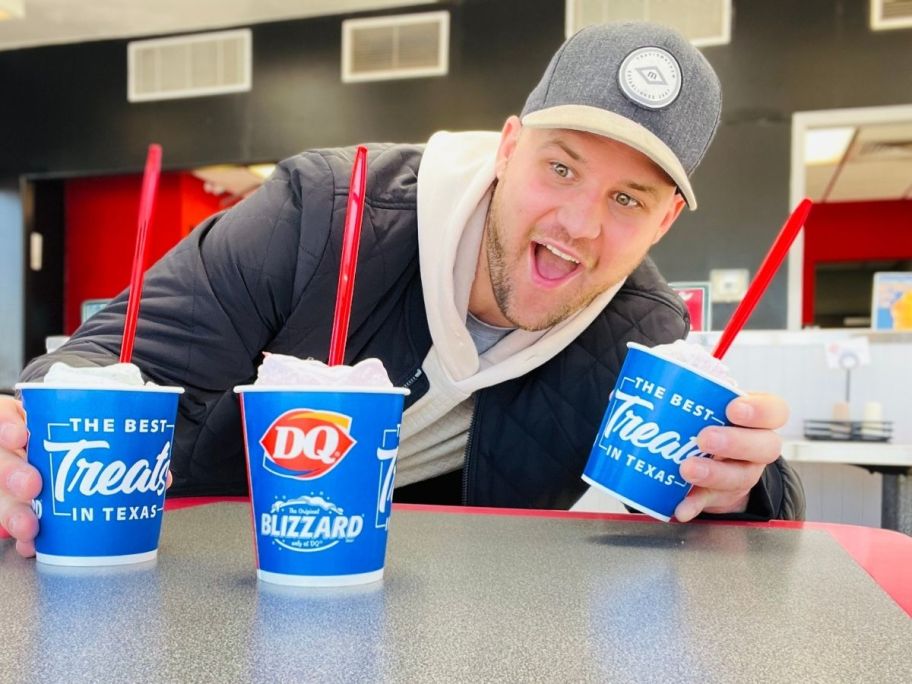 man looking at 2 dairy queen blizzards