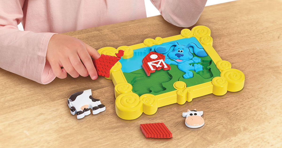 girl playing with 3D Blues clues puzzles on a table