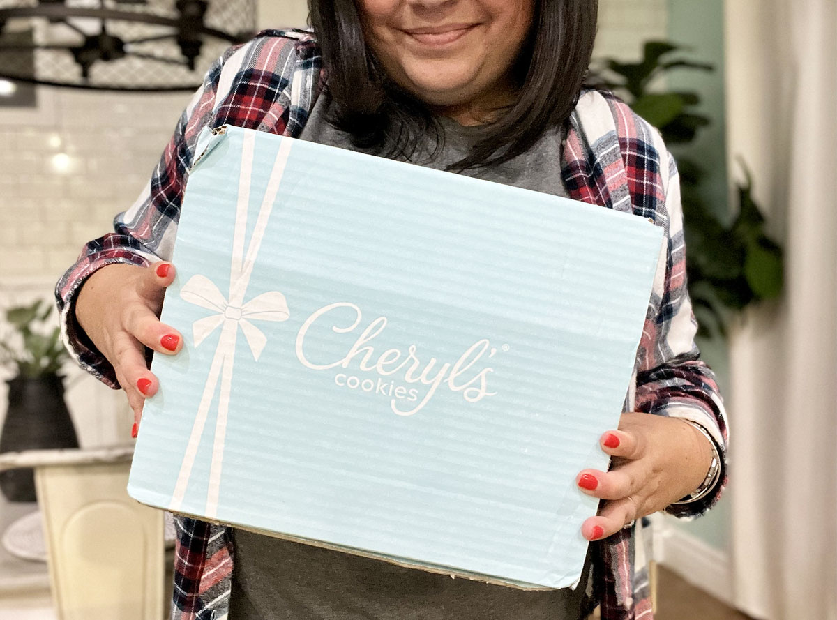 woman holding cheryls cookies box
