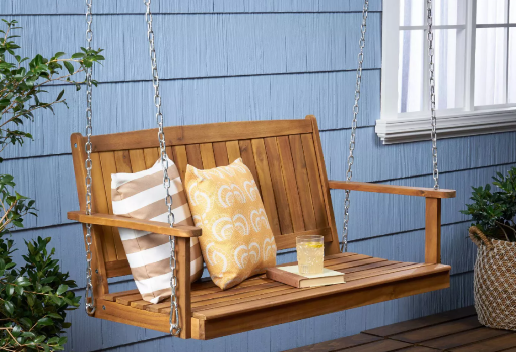 porch swing with pillows on it