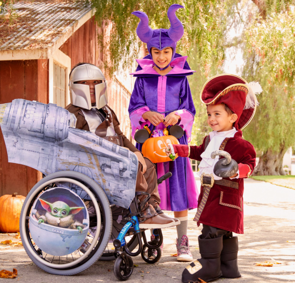 three kids wearing Halloween costumes