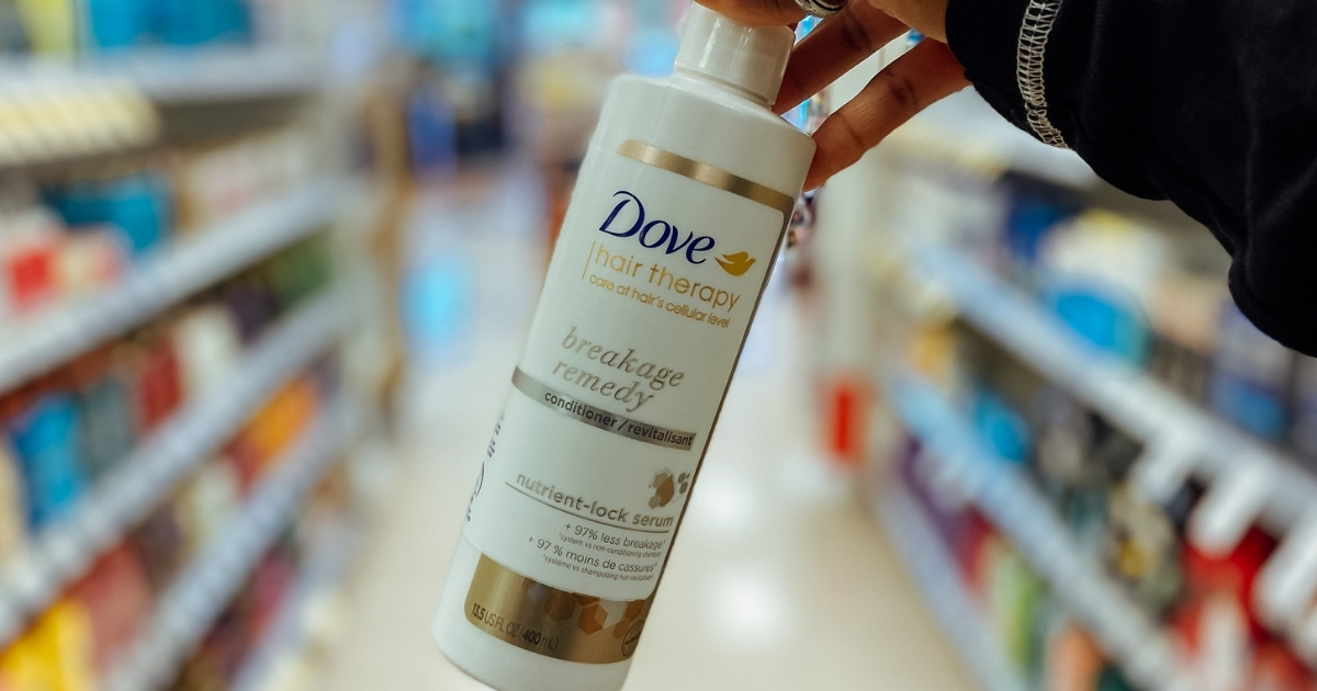 hand holding dove hair therapy in store