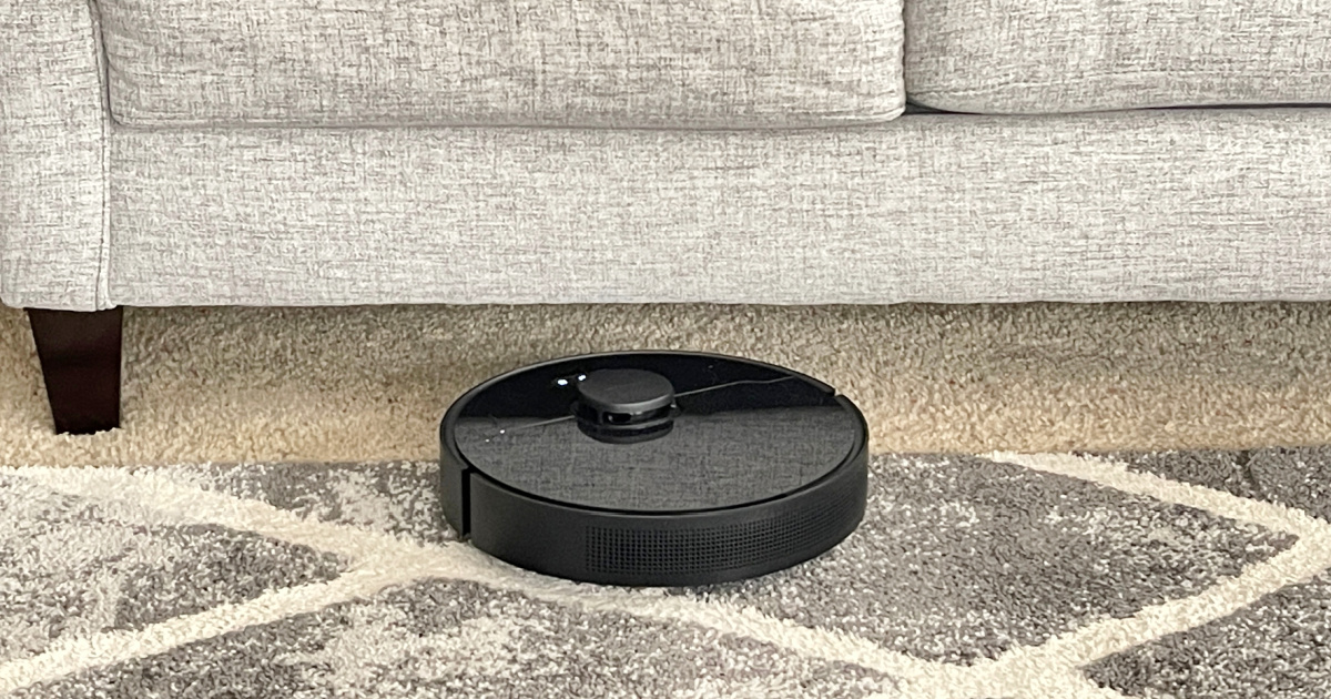 robot vacuum and mop on rug by couch