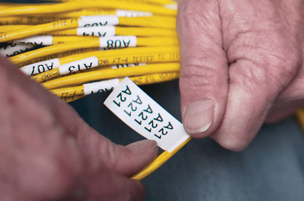 man holding a cord with labels on it