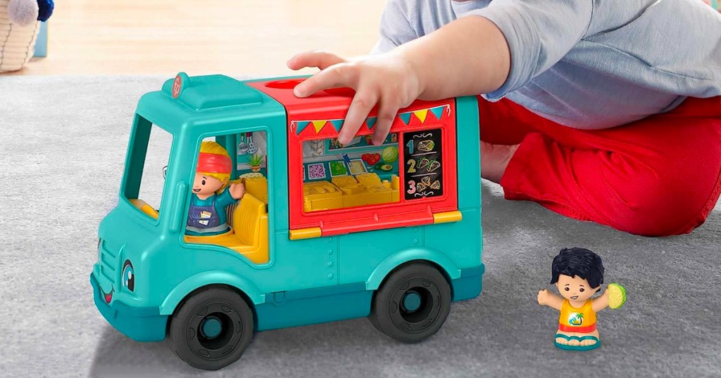 child playing with Fisher-Price Little People Serve it up Food Truck