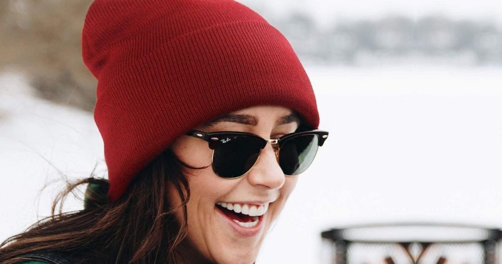 woman wearing a red beanie and sunglasses