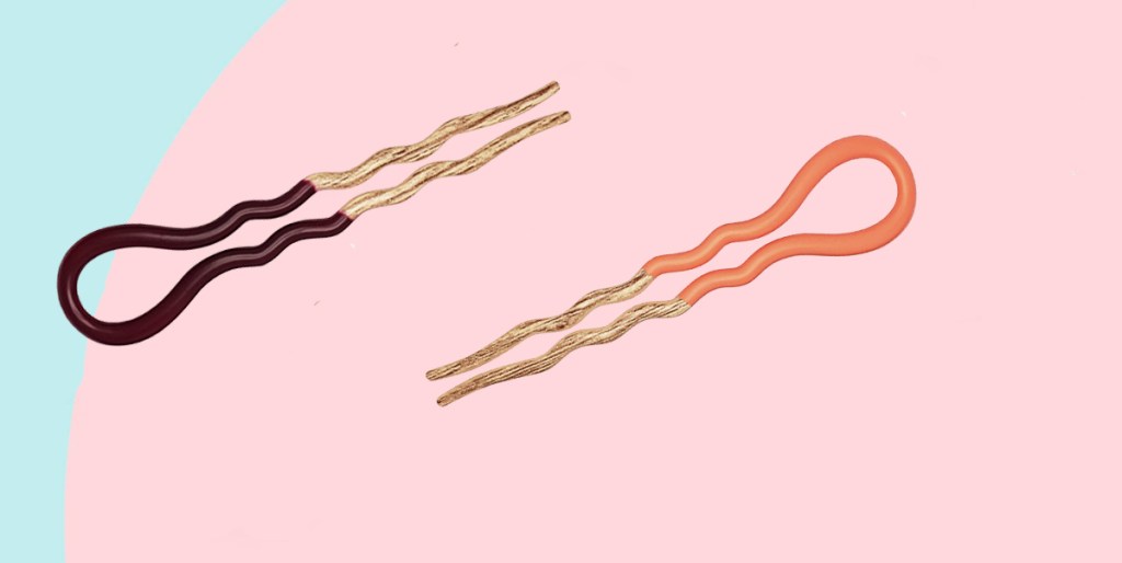 two french hair pins on blue and pink background