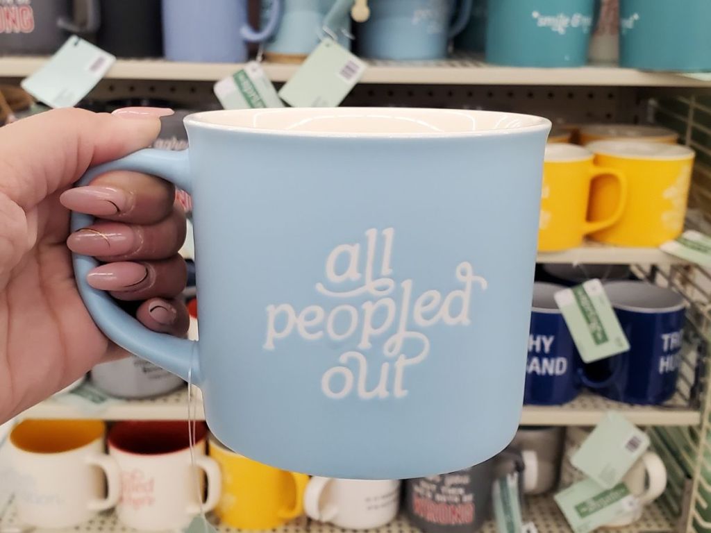 hand holding Hobby Lobby coffee mug that says All Peopled Out