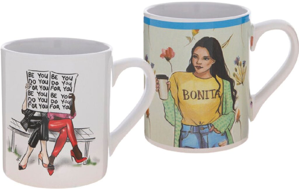 two Hobby Lobby coffee mugs, one that says Be You with two women on it and another with a hispanic woman that says Bonita on it