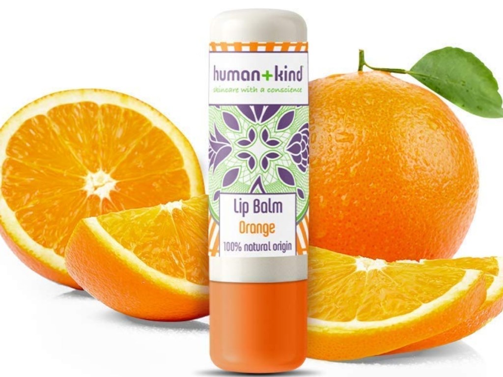 human + kind orange lip balm with oranges in background