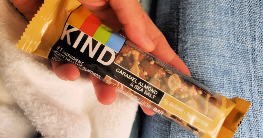 KIND Caramel Almond Sea Salt Bar in hand