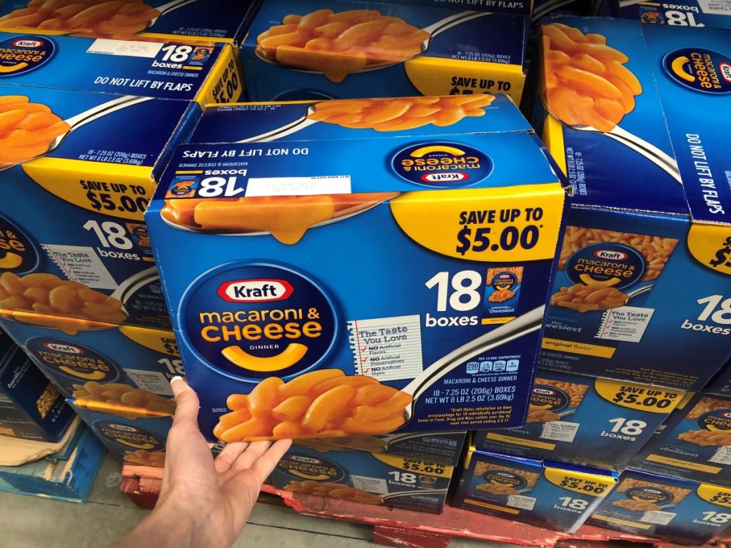 hand holding a multipack of macaroni and cheese