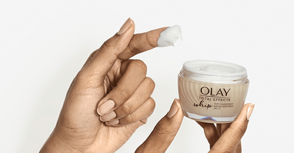 hand holding a bottle of Olay Total Effects Whip