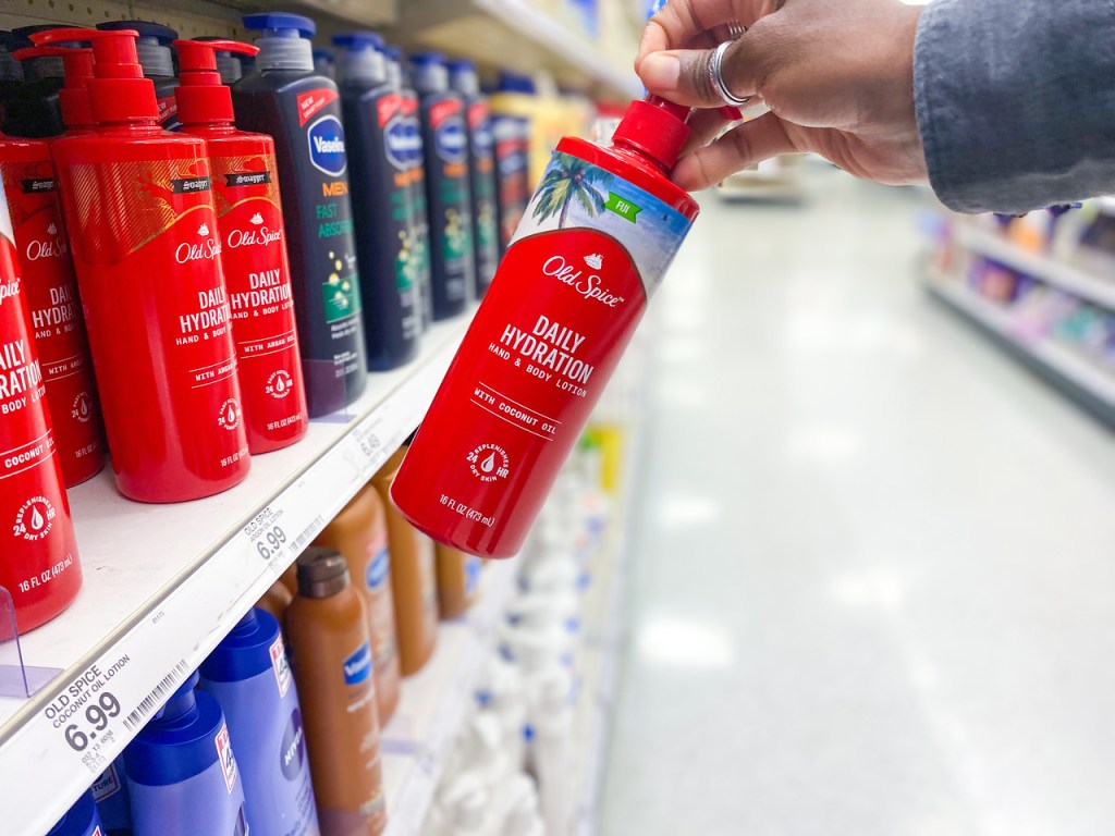 hand pulling Old Spice Daily Hydration Lotion off shelf